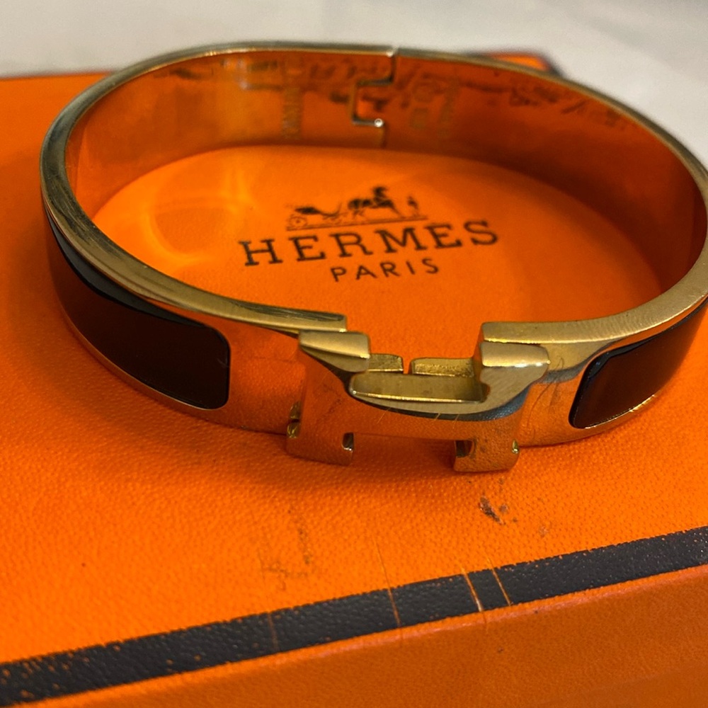 Women’s black and gold Hermes bracelet